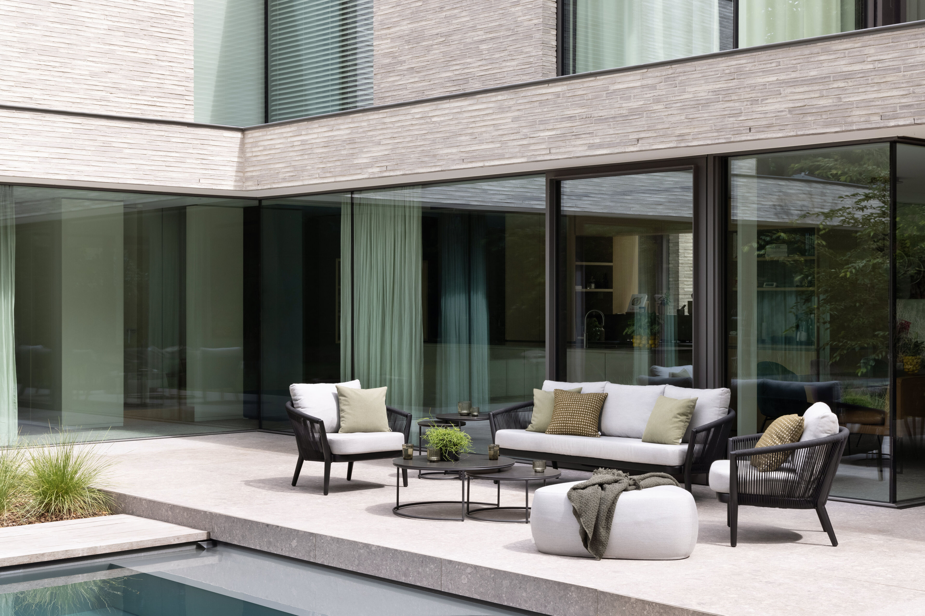 Orso loungebank in zwart aluminium en zwart verticaal geweven ronde rope met Natte Charcoal Chine all weather sunbrella® luxe kussen