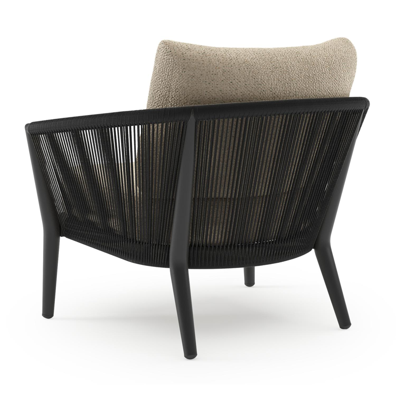 Orso loungestoel in zwart aluminium en zwart verticaal geweven ronde rope met Bora Forest all weather cosytica kussen